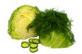 Cut in half young cabbage with a sprig of dill and chopped cucumber on white